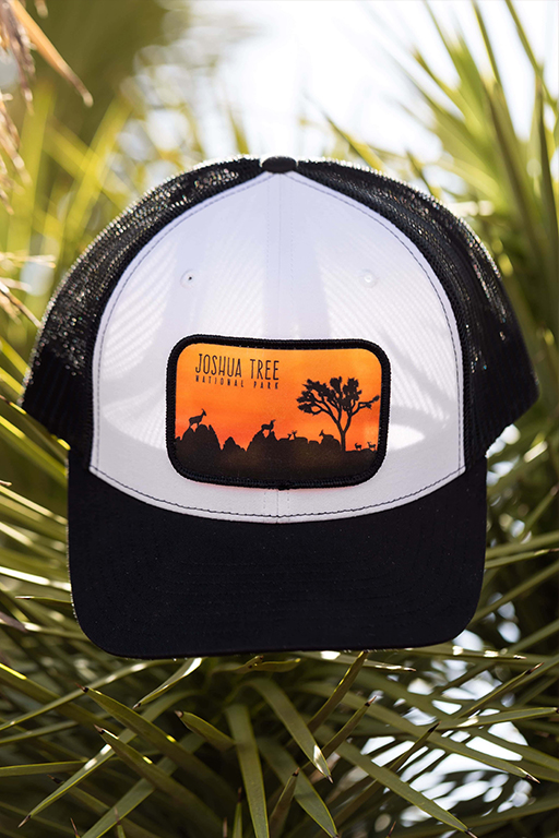 white and black hat with a orange Joshua Tree patch